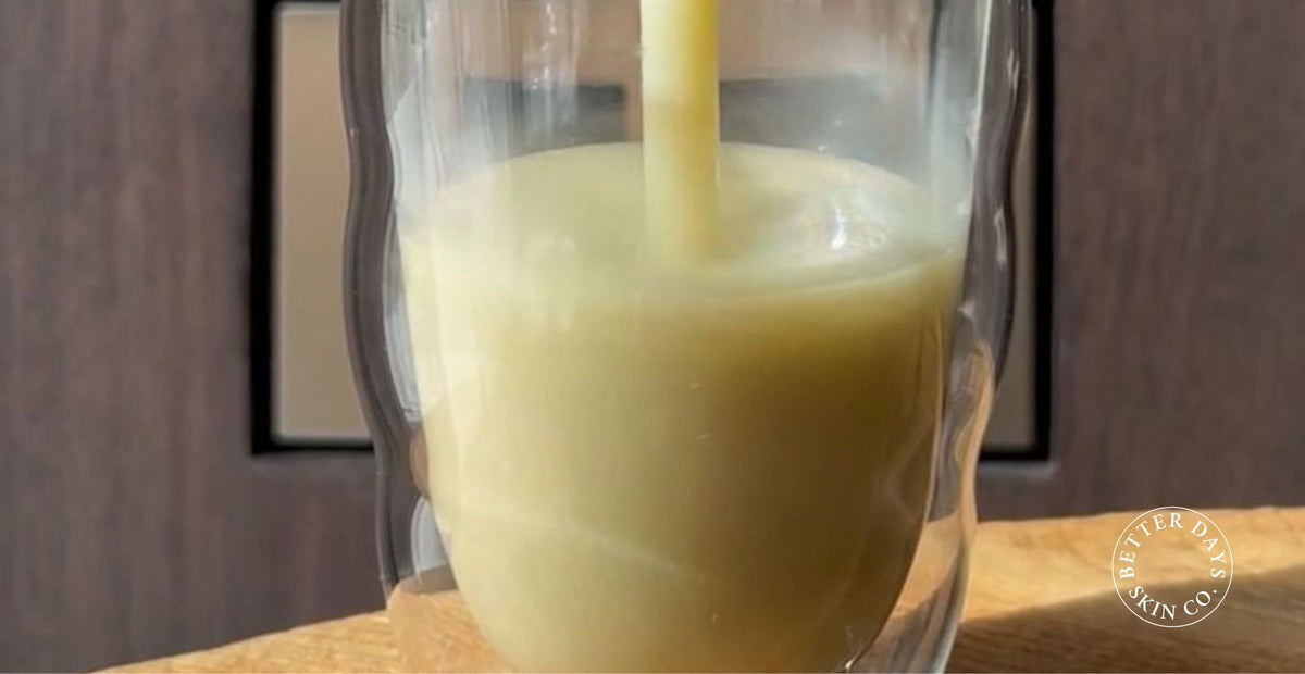 A vibrant TCM Summer Pear Smoothie made with Chinese pear, mung beans, snow mushroom, and lily bulb, served in a glass with a straw, garnished with fresh fruit, showcasing its creamy texture and refreshing color.